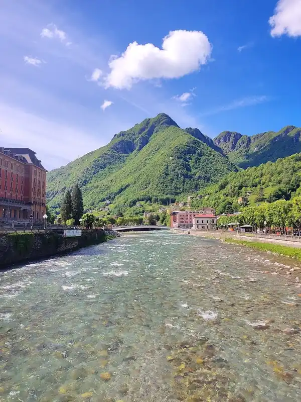 Next Day Delivery San Pellegrino terme rover from a bridge beautiful mountain in the background green mountain and a river clean water